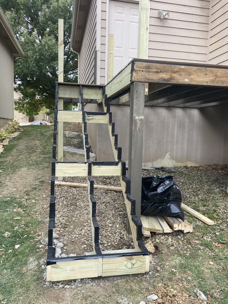 New wood stair stringers wrapped and framed on the ground
