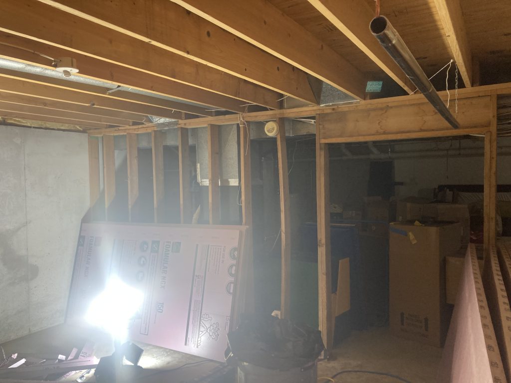 Unfinished basement family room before renovation began