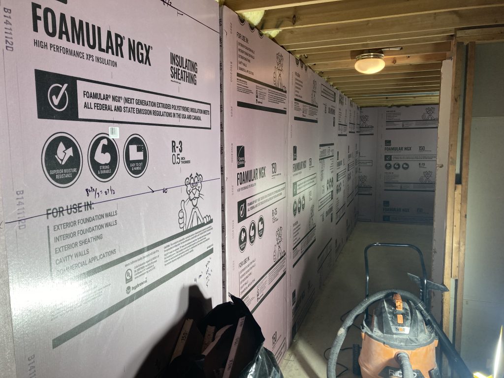 Rigid foam board applied to concrete walls to address moisture and insulation value