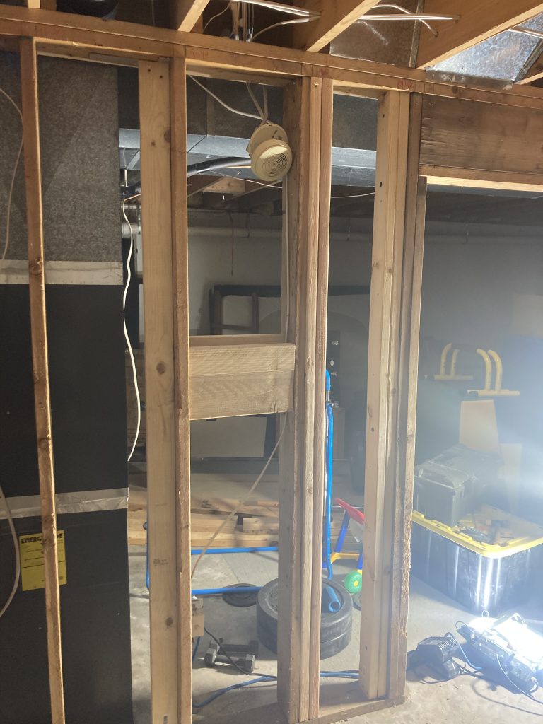 Floor joists jacked up to raise a section of the structural wall for repair