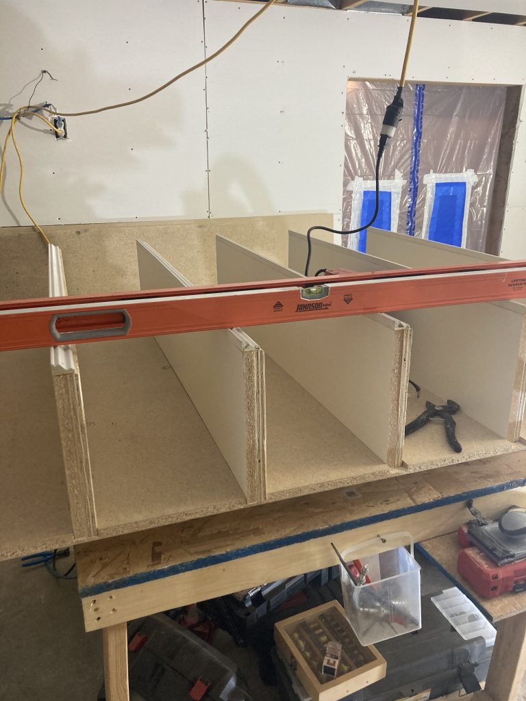 Custom bookcase taking shape with grooved panels built using shop-made jigs