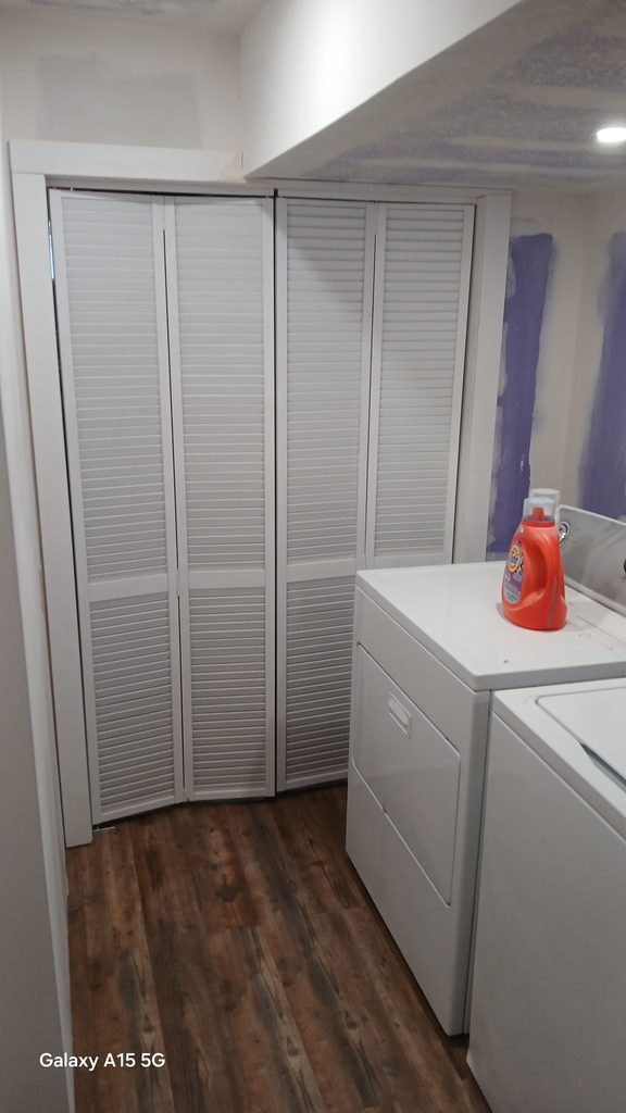 Louvered bifold closet doors installed in the finished laundry room.
