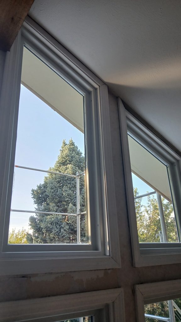 Interior view of matching angled window casings meeting the vaulted ceiling line.
