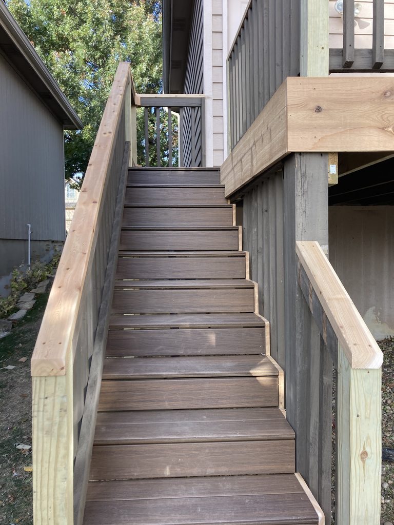 Finished deck stairs with cedar handrail and composite treads