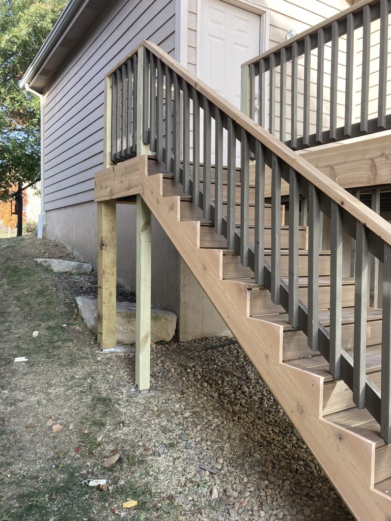 Finished deck stairs running alongside the house
