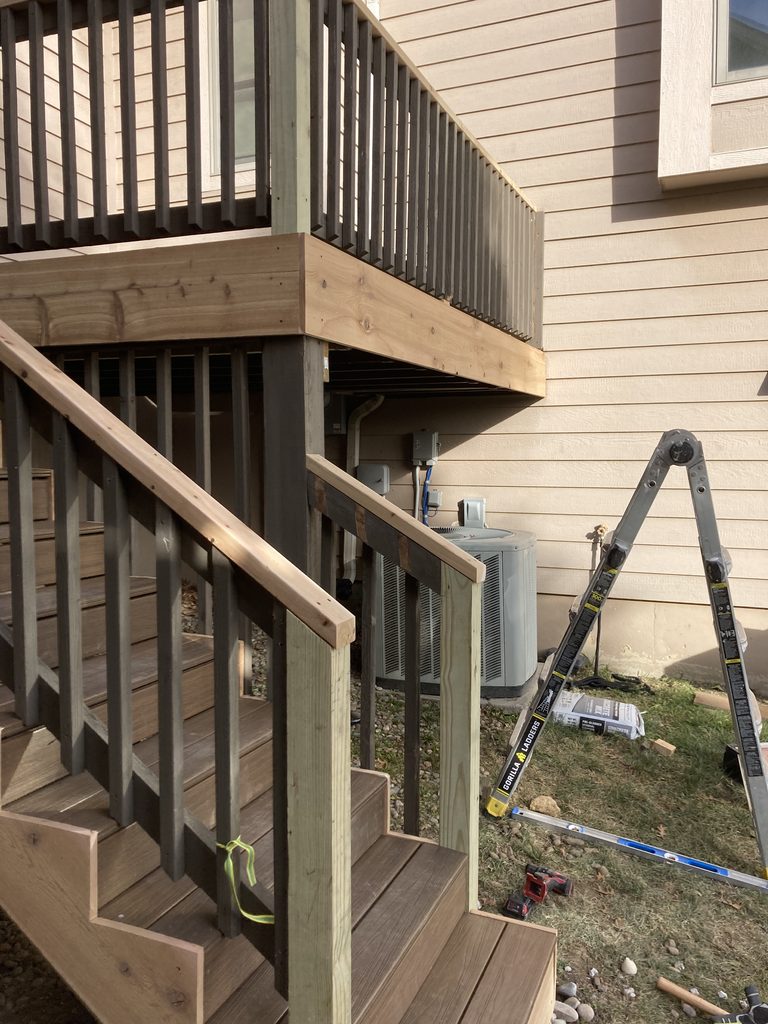 Finished deck railing corner with composite decking