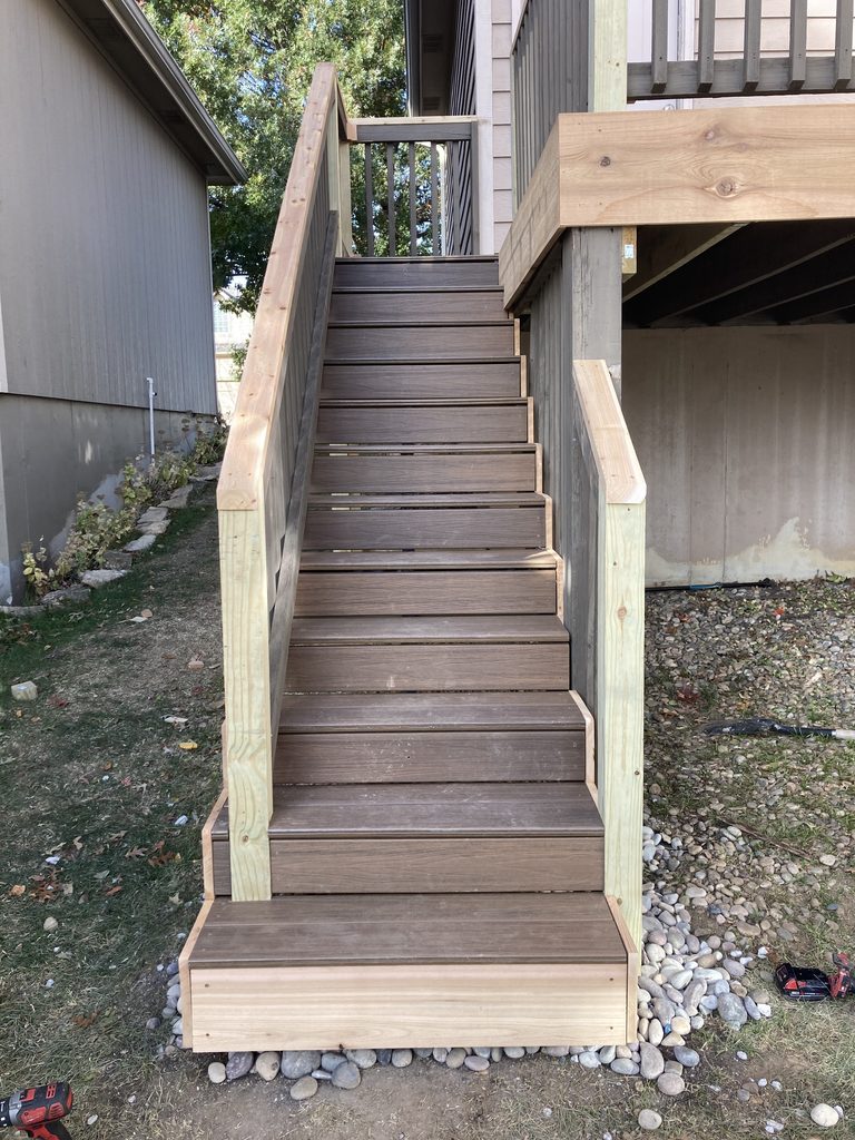 Finished deck stairs with cedar handrail, view from below