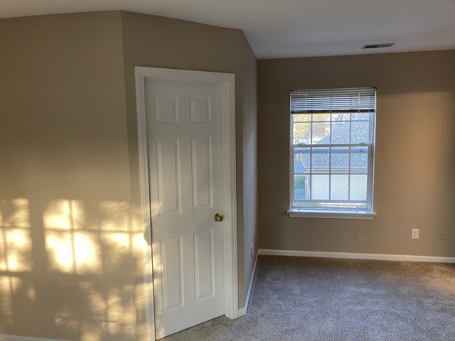 Bedroom corner with a freshly painted white closet door and window after the work.