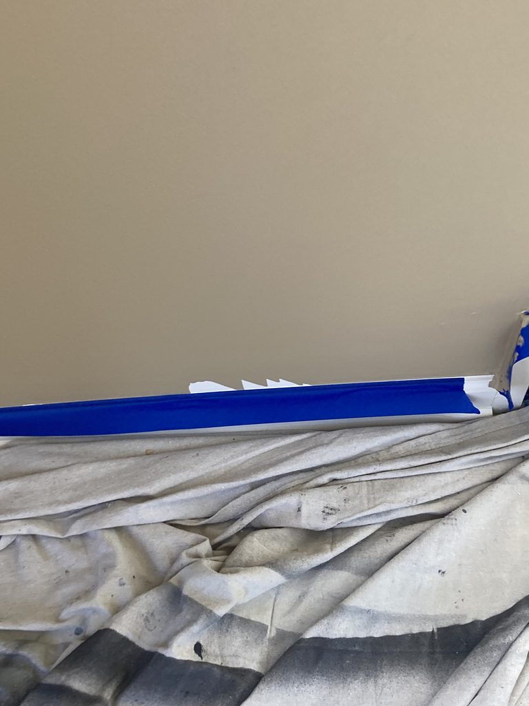 Close-up of a freshly caulked and painted interior wall corner.