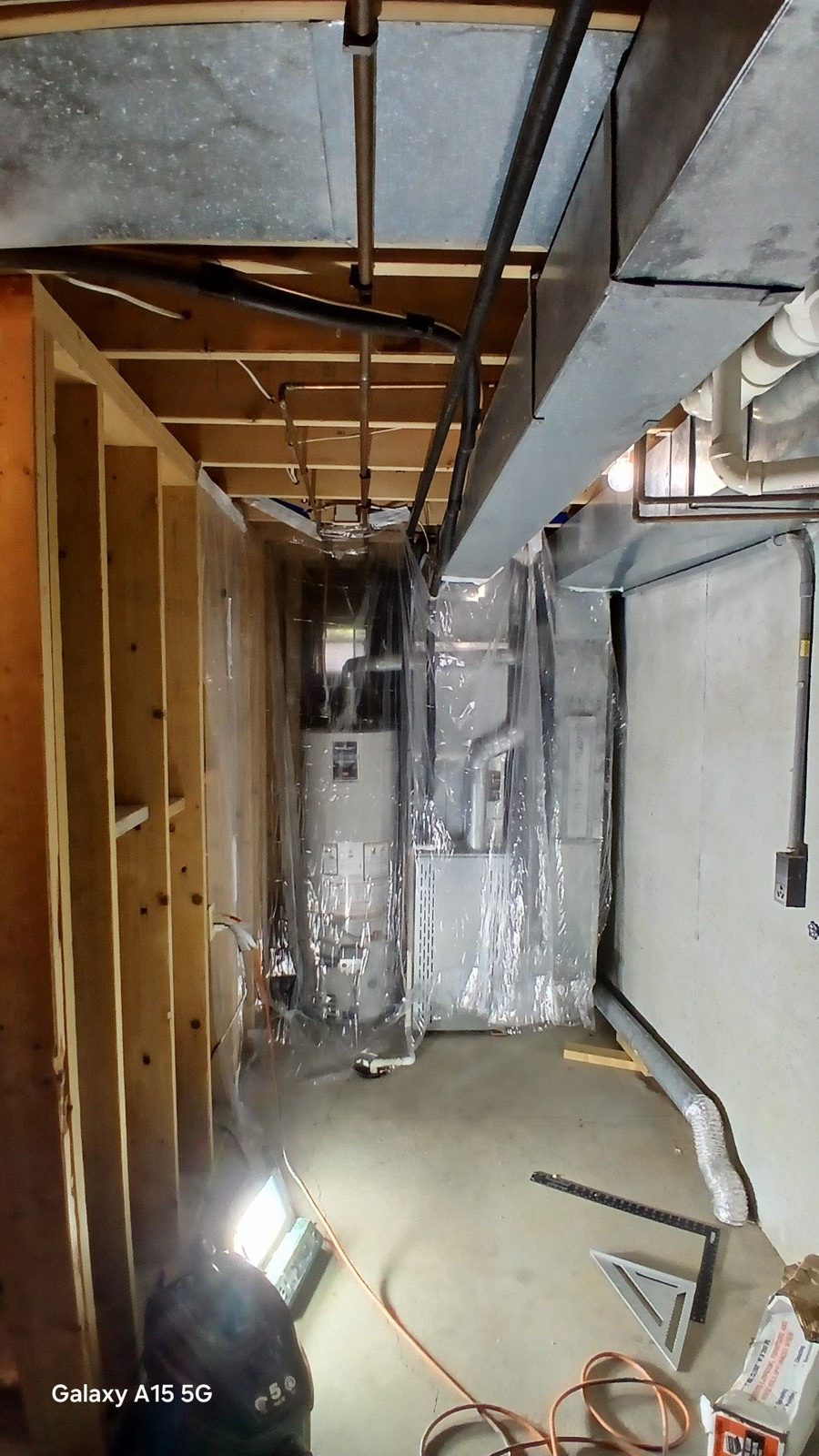 New basement stair opening framed out, looking down at the stringer layout before treads were added.