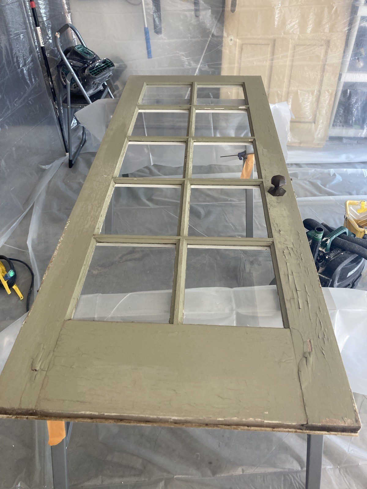 Historic door with multiple layers of peeling paint in original in-situ condition