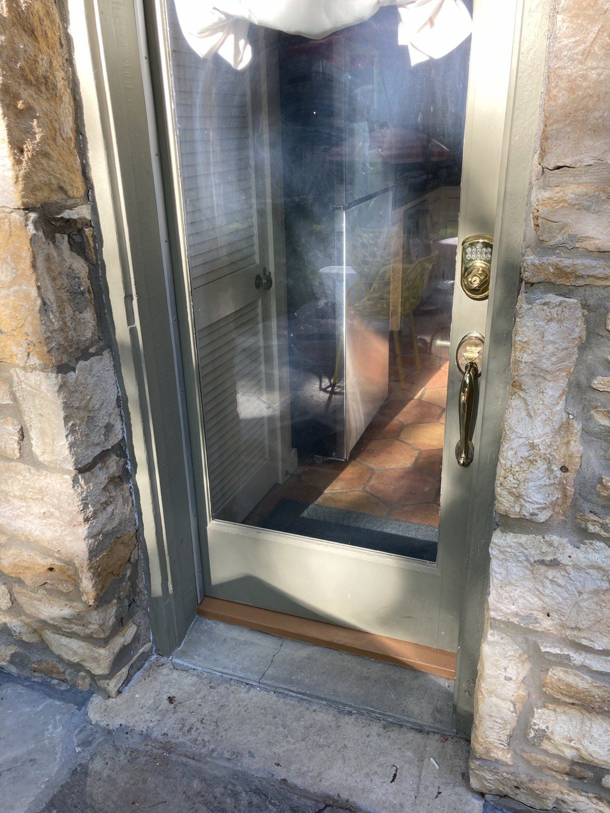 New threshold and sill detail at base of restored door in stone surround